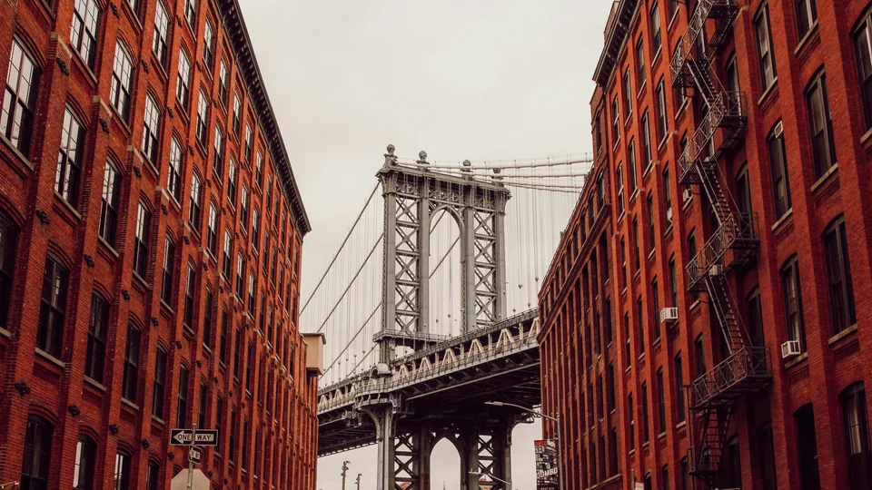 A DUMBO street with the Manhattan Bridge beyond. Example photo, not a listing.